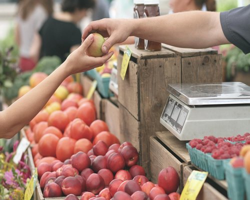Person buying fresh fruit at a local open-air market in Chile